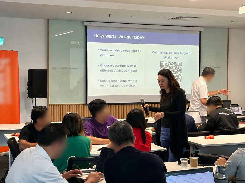 Ivy Wan leading a day 2 session, with participants working in pairs