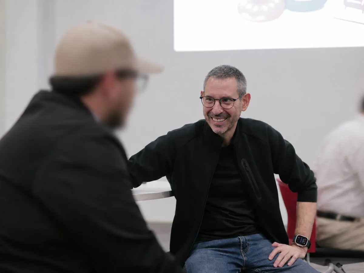 Tom smiling as he talks with a participant during a workshop